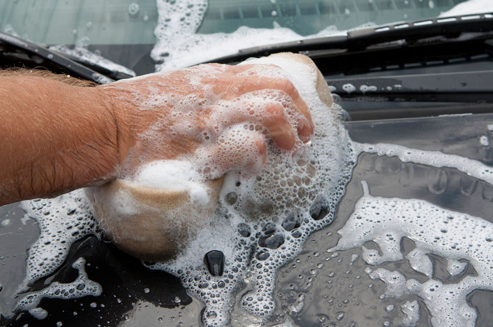 Hombre lavando coche
